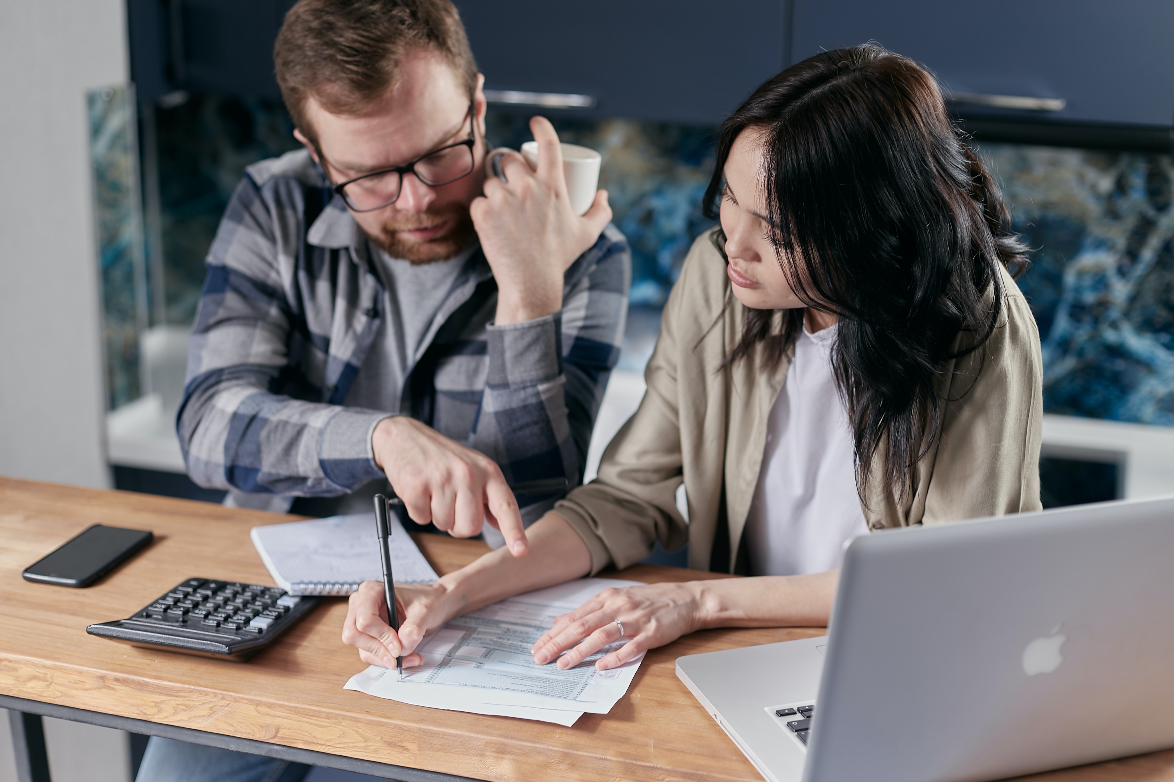 A Man and a Woman Comparing Glass Flooring Estimates